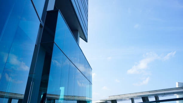 istock bottom view blue glasses building with sky and cloud background. Skyscraper, view of modern business building. Sky view landscape with modern blue glasses building. looking up perspective. Copy space 1497776179