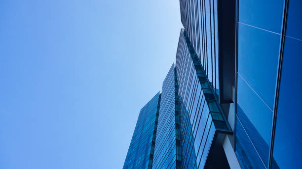 istock bottom view blue glasses building with sky and cloud background. Skyscraper, view of modern business building. Sky view landscape with modern blue glasses building. looking up perspective. Copy space 1497777775