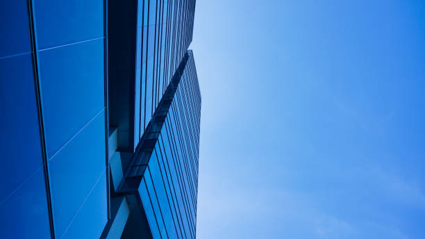 istock bottom view blue glasses building with sky and cloud background. Skyscraper, view of modern business building. Sky view landscape with modern blue glasses building. looking up perspective. Copy space 1497777779