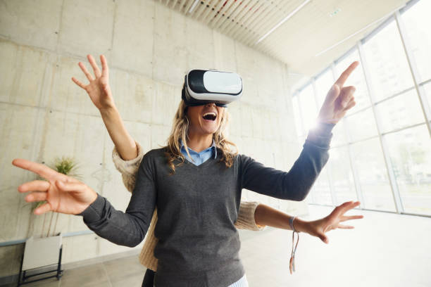 istock Happy businesswoman with multiple hands using VR headset in a hallway. 1497786325