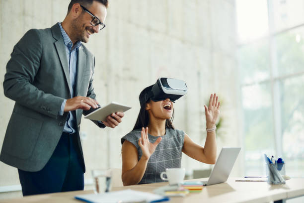 istock Happy business colleagues using wireless technology in the office. 1497786395