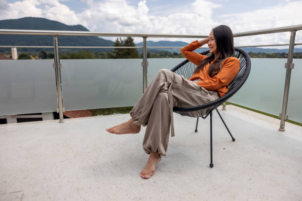 istock Person Sitting And Relaxing On A Chair 1497796315