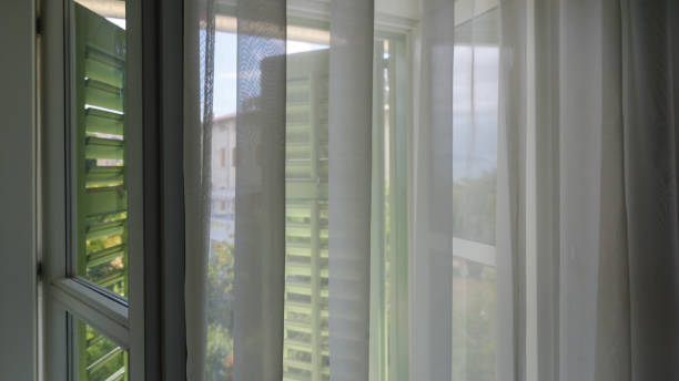 istock Window shutters and curtains at seaside apartment 1497797722