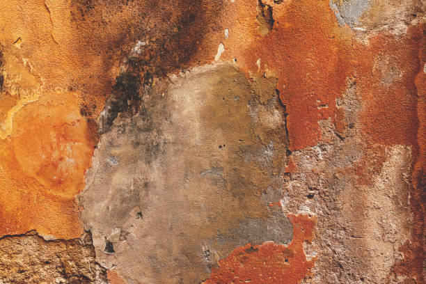 istock Damaged old orange house facade wall as grunge background 1497798925