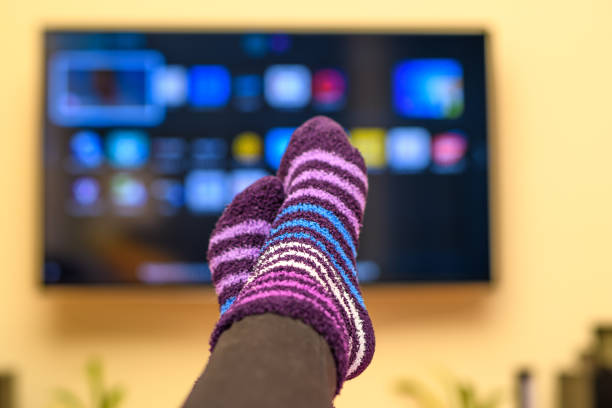 istock Watching TV at home in warm terry socks 1497801783