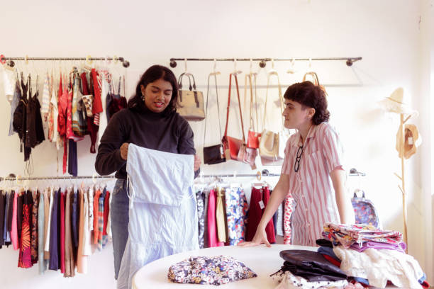 istock Two Multicultural Coworker Shop Owner Sorting Secondhand Clothes in Store 1497801964