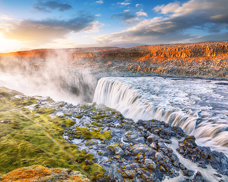 Breathtaking sunset view of the most powerful waterfall in Europe called Dettifoss. Location: Vatnajokull National Park, river Jokulsa a Fjollum, Northeast Iceland, Europe