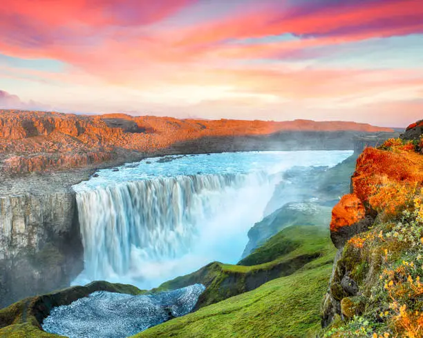 Breathtaking sunset view of the most powerful waterfall in Europe called Dettifoss. Location: Vatnajokull National Park, river Jokulsa a Fjollum, Northeast Iceland, Europe