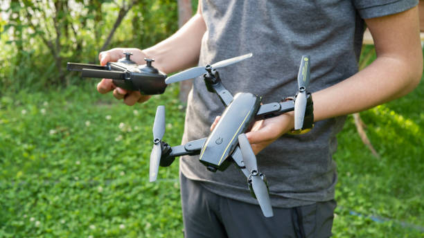 istock Unrecognizable Young male holding drone and remote control 1497803288