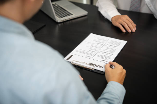 istock Examiner reading a resume during job interview at office Business and human resources concept. 1497805000