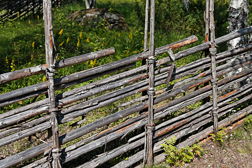 old traditional farmer fence made of birch bark and long sticks at Gammlia