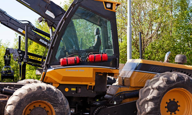 istock Umea, Sweden - Jun 10, 2019: yellow tractors for forestry 1497806409
