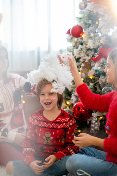 istock Happy siblings having fun during Christmas day at home 1497806642