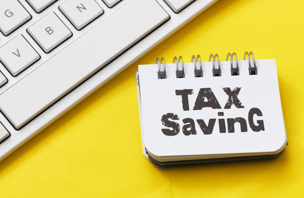 istock The words TAX SAVING in a notebook on a yellow table next to a white keyboard. 1497806728