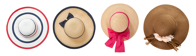 Straw hats with ribbon and bow on white background. Set beach hats summer accessory closeup top view isolated on white