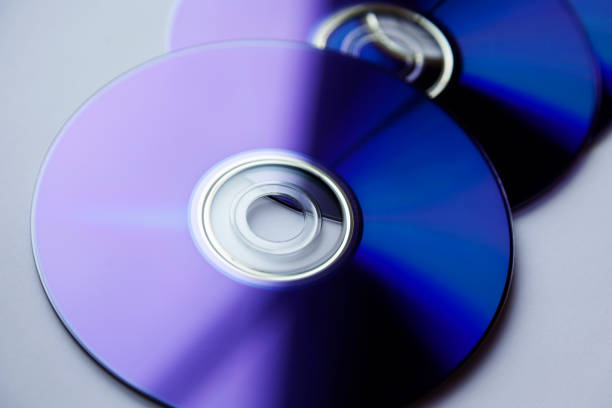 several blu ray discs are in the window on light background - blu ray disc imagens e fotografias de stock