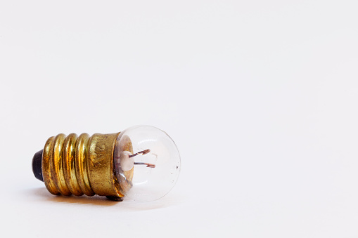 an old small light bulb to experiment on white background