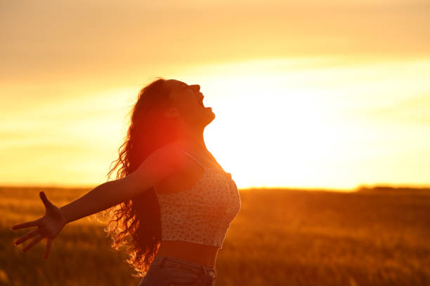 istock Excited woman screaming at sunset 1497807403