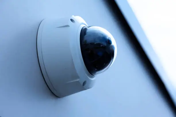 surveillance camera mounted on a wall outdoors