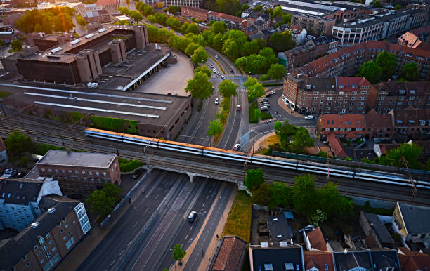 istock Railroad track crossing main city road in Odense 1497809751