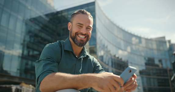 Laughing, city and face of a man with a phone for communication, social media and mobile app. Smile, break and employee portrait on stairs in town with a cellphone for conversation and reading a text
