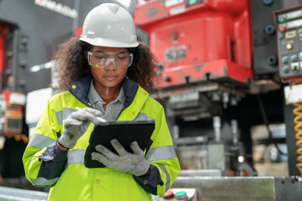 Optimization in the production process contributes to productivity. Production engineer female standing in the factory using digital tablet tracking part of machine breakdown and inspector on the shelf in the production line.