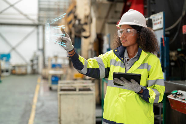 istock Optimization in the production process contributes to productivity. Production planning manager in reflective safety suit holding digital tablet and point to the futuristic digital graphic screen to show how to use drone investigate the machine 1497809937