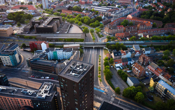 istock Railroad track crossing main city road in Odense 1497810461