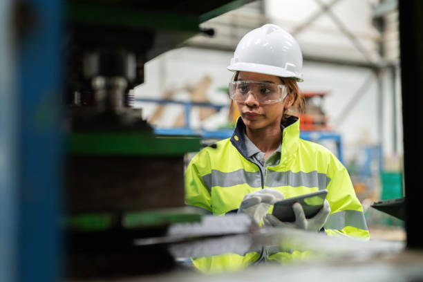 istock Optimizing the production process and tracking the status of the product. Multiethnic engineer worker in the safety suit using digital tablet and check the quality of product in the production shelf at factory. Finding the defect product and separate. 1497810476