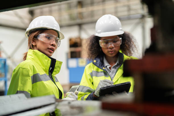 istock Optimizing the production process and tracking the status of the product. Multiethnic engineer worker in the safety suit using digital tablet and check the quality of product in the production shelf at factory. Finding the defect product and separate. 1497810477