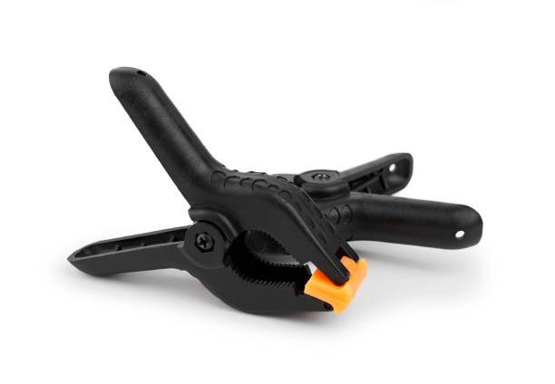 istock Spring clamp isolated on white background. Black plastic clamp. Set of small and big size. Clamping equipment for handicraft, joinery, photography, cars. 1497810869