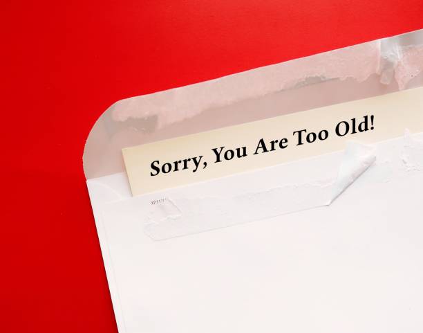istock Torn envelope on red background with message SORRY, YOU ARE TOO OLD - means age is used to categorize and divide people that lead to harm, disadvantage, and injustice - stereotypes of prejudice discrimination by age 1497813425