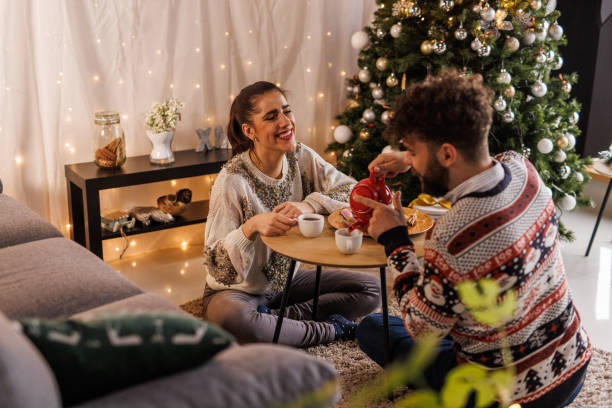 istock Young man pouring tea from a teacup for his girlfriend and himself 1497817927