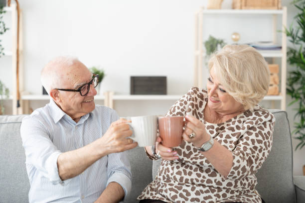 istock Elderly positive couple sharing cup of coffee 1497818598