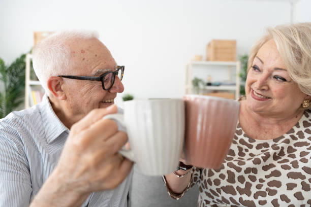 istock Happy elderly couple toasting cups 1497818608