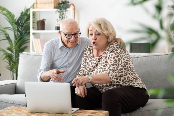 istock Elderly couple talking on laptop 1497818721