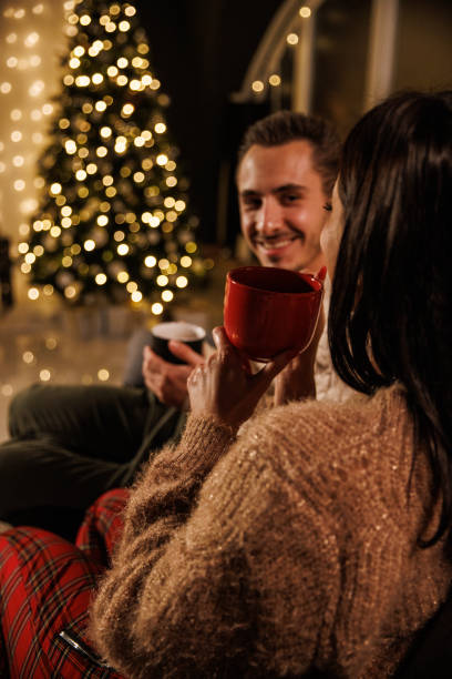 istock Couple having tea, chatting and relaxing on a cozy winter's evening 1497821652