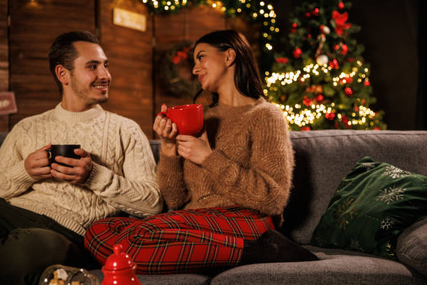 istock Couple having tea, chatting and relaxing on a cozy winter's evening 1497822302