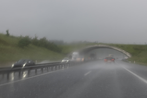 Highway in the rain, poor visibility, blurred road, foggy view, limited visibility. The view from the car.