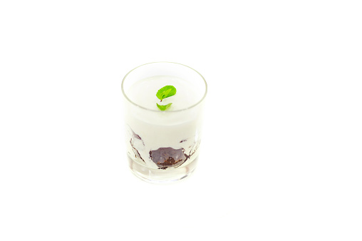 Yogurt dessert in a glass isolated on white background.