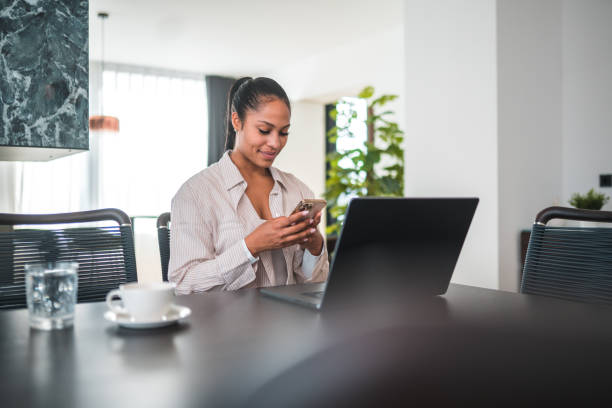 istock Experienced Biracial Female Digital Nomad Working Online in Home Kitchen 1497826100