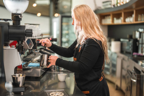 istock Talented Female Barista Making Coffee Creations in the Cafeteria 1497827421