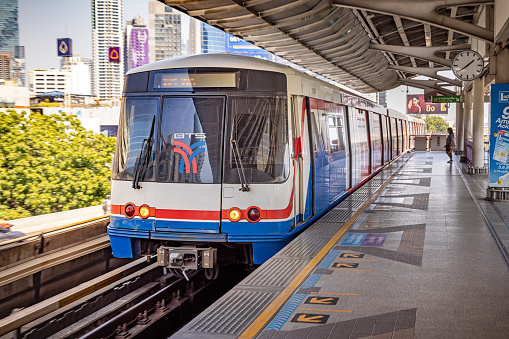 Saphan Taksin, Bangkok, Thailand - March 26th 2023: One of the famous BTS sky trains at a station in the capital of Thailand