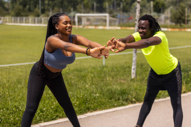 istock Young couple stretching before a run in a public park 1497831462