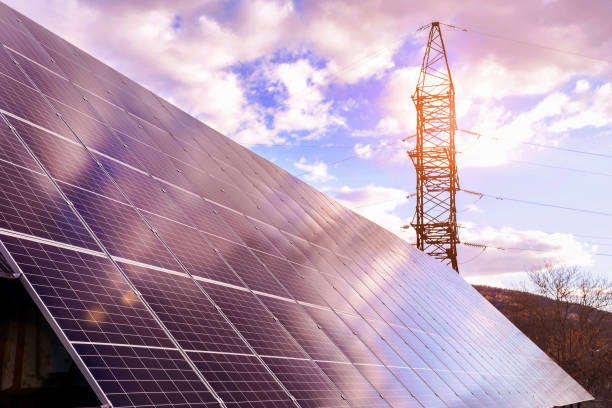 istock Solar Panels  with High Voltage Electric Pylon 1497832473