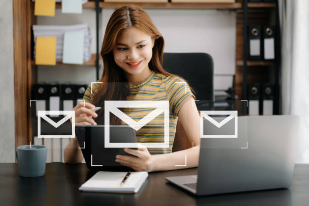 istock Woman hands using Laptop, tablet typing on keyboard and surfing the internet with email icon, email marketing concept, send e-mail or newsletter, online working internet network technology. 1497833844