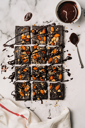 Above shot of fresh baked brownie with chocolate dressing over it