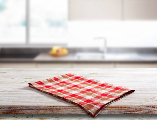 istock Napkin on wooden desk. Kitchen background. 1497841701