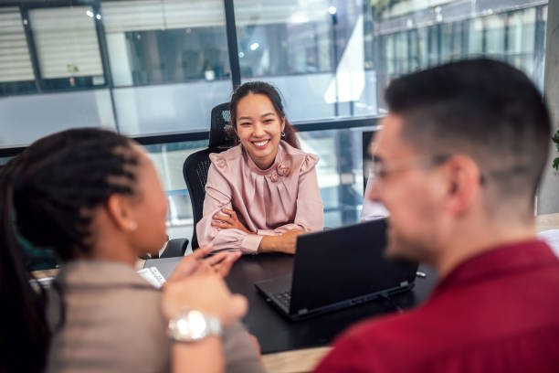 istock Financial advisor analyzing documents with her clients in a meeting in the office. 1497842268