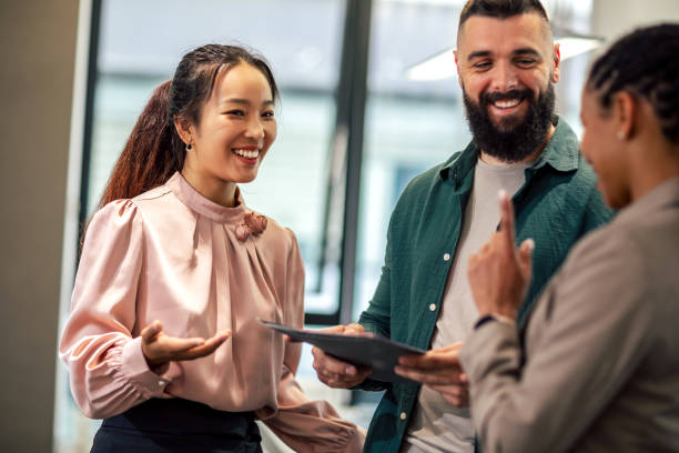 istock A business team is standing in a modern office and having a discussion 1497842277